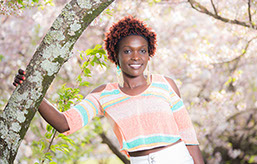 Photographers Tuscaloosa. Senior portrait photography of a black girl in a cherry blossum grove.