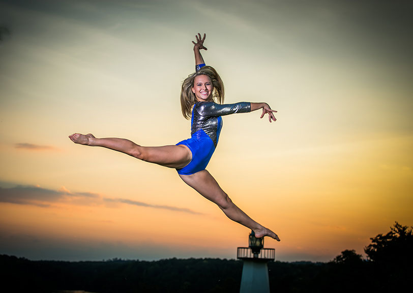 Sunset senior picture in gymnastics leotard in Tuscaloosa, Alabama.