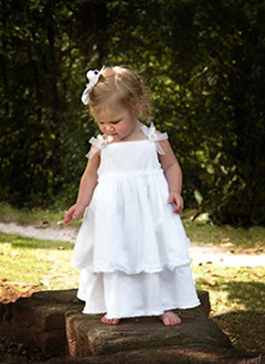 Tuscaloosa, Alabama children's photographer. Little girl in white dress outside in Tuscaloosa, Alabama.