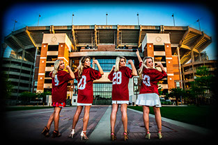 Four University Of Alabama graduates at the Walk of Champions at Bryant-Denny Stadium on campus. graduation pictures